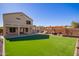 Spacious backyard with artificial turf and a pergola at 11830 W Avenida Del Sol --, Sun City, AZ 85373