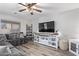 Living room with gray sectional sofa and white shelving unit at 11830 W Avenida Del Sol --, Sun City, AZ 85373