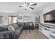 Living room with gray sectional sofa and sliding door to backyard at 11830 W Avenida Del Sol --, Sun City, AZ 85373