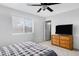 Bedroom with dresser, TV, and ceiling fan at 1195 E Dust Devil Dr, San Tan Valley, AZ 85143