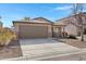 Single-story house with a two-car garage and desert landscaping at 1195 E Dust Devil Dr, San Tan Valley, AZ 85143