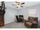 Bright home office features a comfortable armchair, desk, and ceiling fan at 1195 E Dust Devil Dr, San Tan Valley, AZ 85143