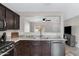 Modern kitchen with dark wood cabinets and granite countertops at 1195 E Dust Devil Dr, San Tan Valley, AZ 85143