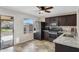 Modern kitchen with dark cabinetry, granite countertops, and stainless steel appliances at 1195 E Dust Devil Dr, San Tan Valley, AZ 85143