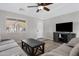 Bright and airy living room featuring a flat-screen TV and comfortable seating at 1195 E Dust Devil Dr, San Tan Valley, AZ 85143