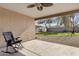 Covered patio with grassy backyard and rocking chair at 1195 E Dust Devil Dr, San Tan Valley, AZ 85143