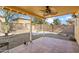 Backyard patio with fire pit and ceiling fan at 12000 W Bloomfield Rd, El Mirage, AZ 85335