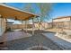 Backyard with covered patio and fire pit at 12000 W Bloomfield Rd, El Mirage, AZ 85335