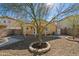 Backyard with patio, trees and fire pit at 12000 W Bloomfield Rd, El Mirage, AZ 85335