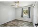 Well-lit bedroom with wood-look flooring and a ceiling fan at 12000 W Bloomfield Rd, El Mirage, AZ 85335