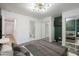 Bedroom with wood-look floors, mirrored closet, and a view of the bathroom at 12000 W Bloomfield Rd, El Mirage, AZ 85335