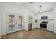 Modern kitchen with stainless steel appliances and white cabinets at 12000 W Bloomfield Rd, El Mirage, AZ 85335