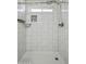 Clean shower with white tile, and a built-in shelf at 12000 W Bloomfield Rd, El Mirage, AZ 85335