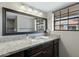 Bathroom features granite vanity, large mirror, and a view of the shower at 1211 N Miller Rd # 201, Scottsdale, AZ 85257