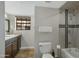 Bathroom with granite countertop, large mirror, and tub shower combo at 1211 N Miller Rd # 201, Scottsdale, AZ 85257