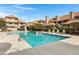 Community pool with surrounding lounge chairs and landscaping at 1211 N Miller Rd # 201, Scottsdale, AZ 85257