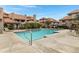 Inviting community pool with plenty of lounge chairs and a waterfall feature at 1211 N Miller Rd # 201, Scottsdale, AZ 85257