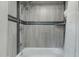 Clean shower with grey tile and a built-in shelf at 1211 N Miller Rd # 201, Scottsdale, AZ 85257