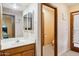 Clean bathroom with a sink, toilet, and access to the exterior at 12210 N 76Th Pl, Scottsdale, AZ 85260