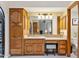 Bathroom with wood vanity, granite countertop, and walk-in shower at 12210 N 76Th Pl, Scottsdale, AZ 85260