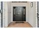 Elegant entryway with a black metal door and tile flooring at 12210 N 76Th Pl, Scottsdale, AZ 85260