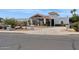 Front view of a large home with a long driveway at 12210 N 76Th Pl, Scottsdale, AZ 85260