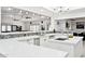 Modern kitchen with white cabinets, quartz countertops and a large island at 12210 N 76Th Pl, Scottsdale, AZ 85260