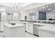 Bright kitchen featuring white cabinets, quartz countertops, and a large island at 12210 N 76Th Pl, Scottsdale, AZ 85260