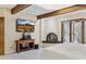 Main bedroom with fireplace and a large flat screen TV at 12210 N 76Th Pl, Scottsdale, AZ 85260