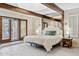 Main bedroom with king-size bed and exposed wood beams at 12210 N 76Th Pl, Scottsdale, AZ 85260