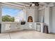 Relaxing outdoor kitchen area with a built-in grill and fireplace at 12210 N 76Th Pl, Scottsdale, AZ 85260