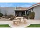 Stone patio with table and benches near house at 12210 N 76Th Pl, Scottsdale, AZ 85260