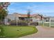 Landscaped backyard with putting green and a view of the house at 12210 N 76Th Pl, Scottsdale, AZ 85260