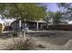 House backyard with gravel, trees, and a patio at 1229 E Prickly Pear St, Casa Grande, AZ 85122