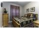 Bedroom with wooden bed frame and red and white checkered curtains at 1229 E Prickly Pear St, Casa Grande, AZ 85122