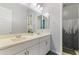 Bathroom with double sink vanity, white cabinets, and an ornate mirror at 12349 N 145Th Ave, Surprise, AZ 85379