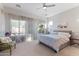 Serene bedroom featuring soft natural light, a ceiling fan, and neutral decor at 12349 N 145Th Ave, Surprise, AZ 85379