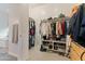 Spacious walk-in closet with custom shelving, shoe storage, and ample hanging space at 12349 N 145Th Ave, Surprise, AZ 85379