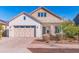 Charming single-story home with a two-car garage and well-maintained front yard landscaping at 12349 N 145Th Ave, Surprise, AZ 85379