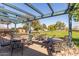 Inviting patio with shade and furnishings overlooking the community green space with picnic shelter at 12349 N 145Th Ave, Surprise, AZ 85379