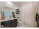 Clean bathroom with a shower/tub combo and dark vanity at 1238 W Silver Creek Ln, San Tan Valley, AZ 85140