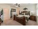 Main bedroom with king-size bed and ensuite bathroom at 1238 W Silver Creek Ln, San Tan Valley, AZ 85140