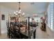 Open dining area with dark wooden table and chandelier at 1238 W Silver Creek Ln, San Tan Valley, AZ 85140