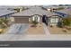 Single-story home with a two-car garage and landscaped front yard at 1238 W Silver Creek Ln, San Tan Valley, AZ 85140