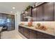 Modern kitchen with dark wood cabinets, granite countertops, and gas cooktop at 1238 W Silver Creek Ln, San Tan Valley, AZ 85140