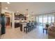 Open concept kitchen with island, stainless steel appliances, and adjacent living space at 1238 W Silver Creek Ln, San Tan Valley, AZ 85140