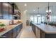 Modern kitchen with dark cabinetry, granite countertops and gas cooktop at 1238 W Silver Creek Ln, San Tan Valley, AZ 85140