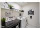 Bright laundry room with washer, dryer, and shelving at 1238 W Silver Creek Ln, San Tan Valley, AZ 85140