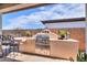 Outdoor kitchen with built-in grill, seating, and decorative accents at 1238 W Silver Creek Ln, San Tan Valley, AZ 85140