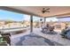 Covered patio with seating, a built-in grill, and a spa at 1238 W Silver Creek Ln, San Tan Valley, AZ 85140